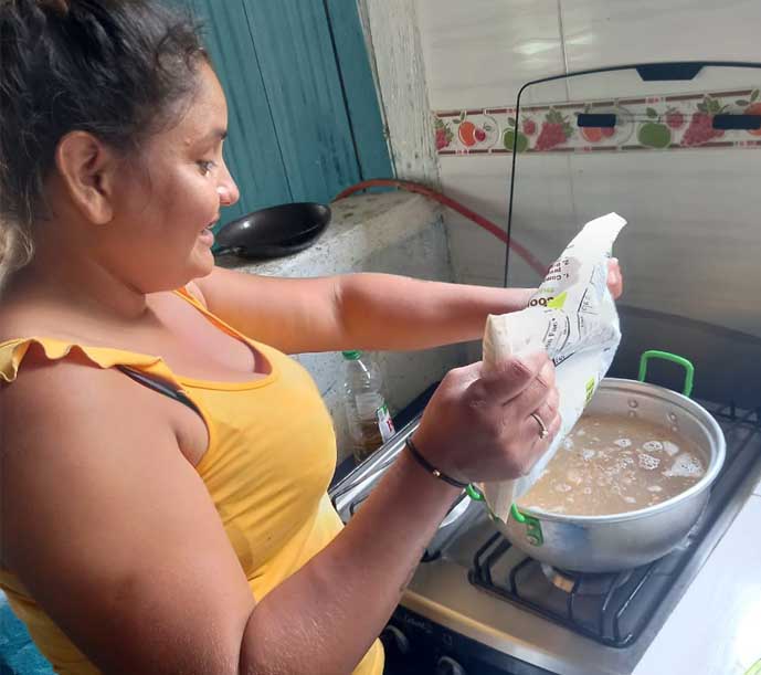 Image of a woman preparing nutritious Breedlove food.